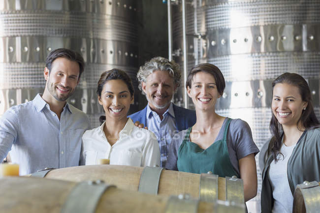 Portrait confident winery employees in cellar — Stock Photo