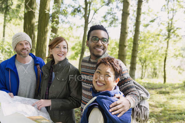Friends with map hiking in woods — Stock Photo