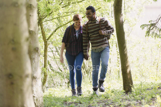 Couple holding hands hiking in woods — Stock Photo