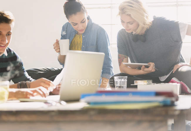 College students studying with coffee, laptop and digital tablet — Stock Photo