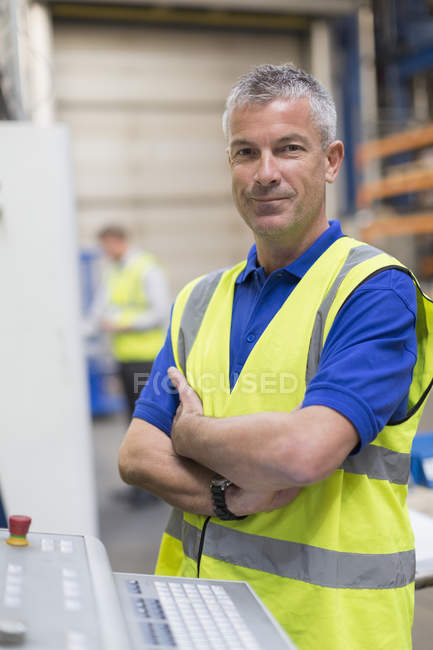Portrait confident worker at control panel in steel factory — Stock Photo