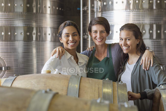 Portrait smiling women in winery cellar — Stock Photo