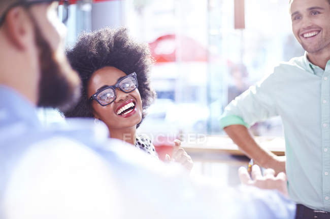 Laughing businesswoman in meeting at modern cafe — Stock Photo