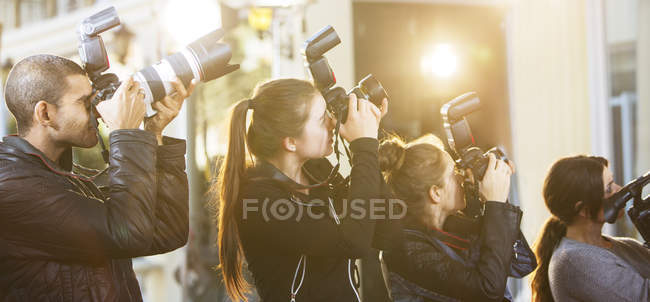 Paparazzi photographers  in a row pointing cameras at event — Stock Photo