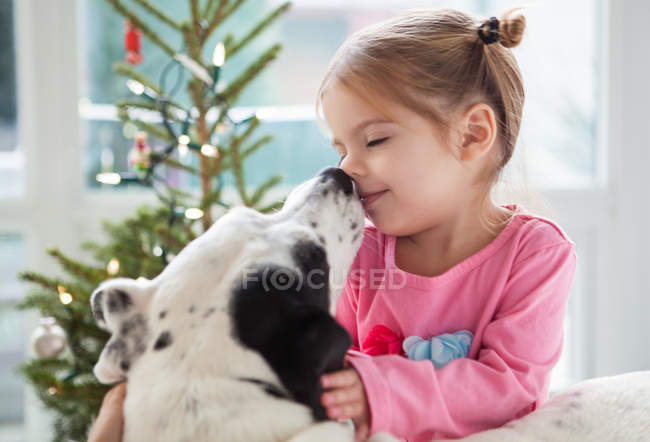 Dog licking girls face — Stock Photo