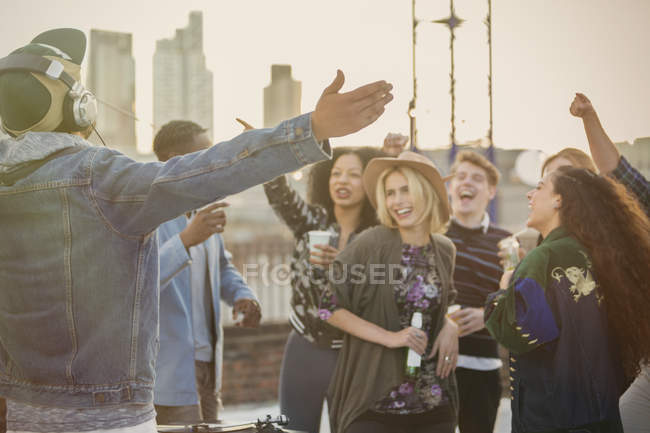 Crowd cheering for DJ at rooftop party — Stock Photo