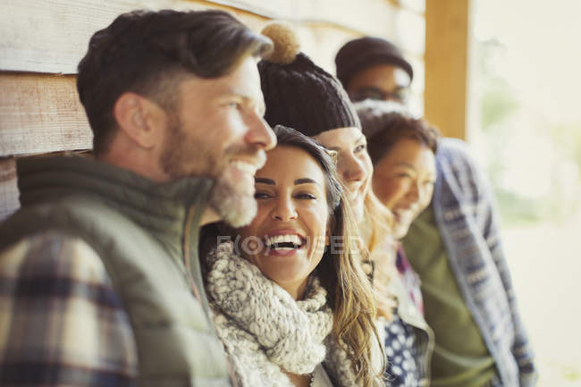 Friends laughing outside cabin — Stock Photo