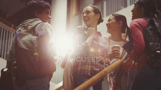 Smiling college students on stairway — Stock Photo