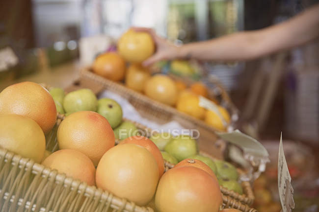 Закрыть свежие апельсины в корзине на рынке — стоковое фото