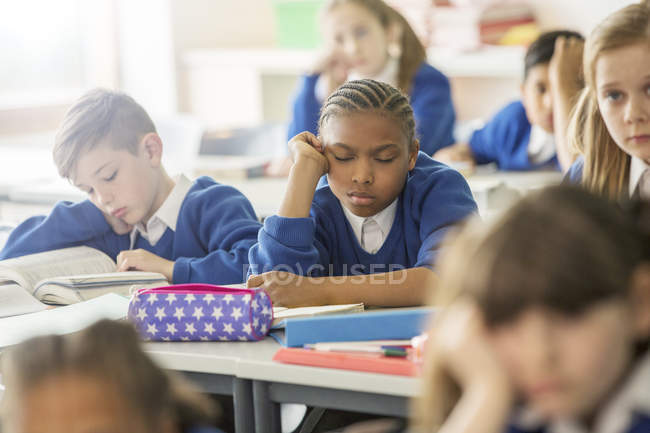 Elementary school children asleep and bored in classroom — Stock Photo