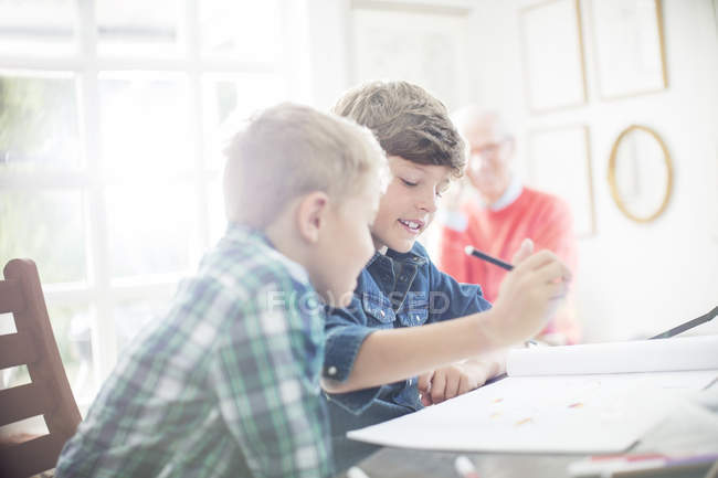 Boys drawing together at table in home — Stock Photo