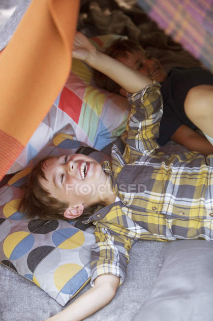 Laughing boys playing in camping tent — Stock Photo