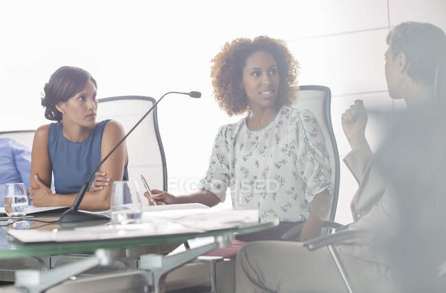 Portrait of three women having discussion at conference table — Stock Photo