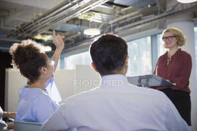 Businesswoman asking question in conference audience — Stock Photo