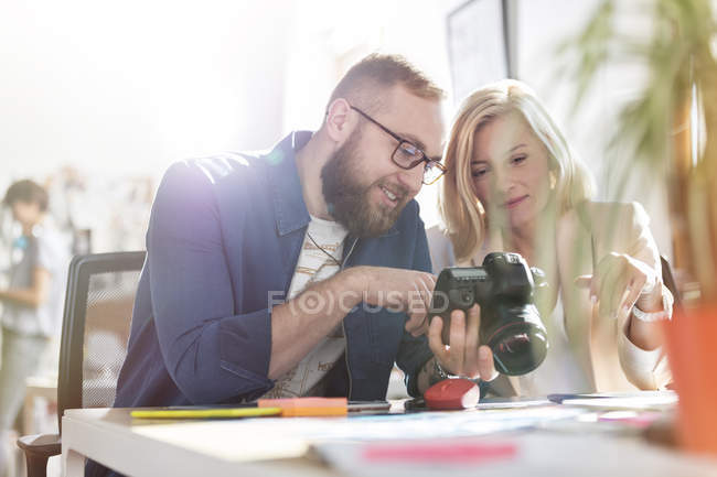 Photographer design professionals using SLR camera in office — Stock Photo