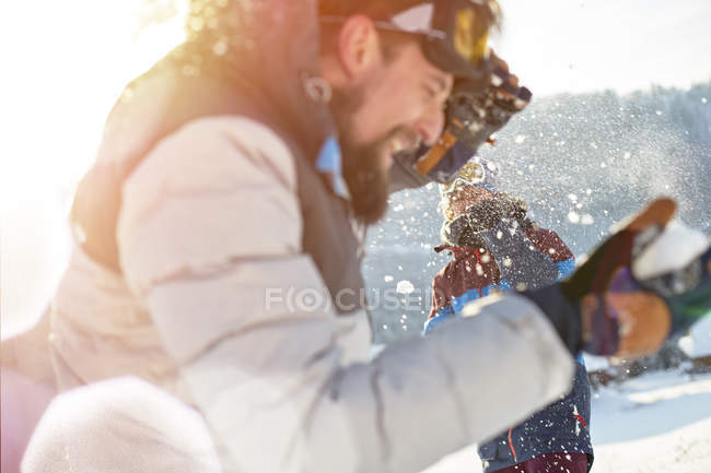Playful couple enjoying snowball fight — Stock Photo