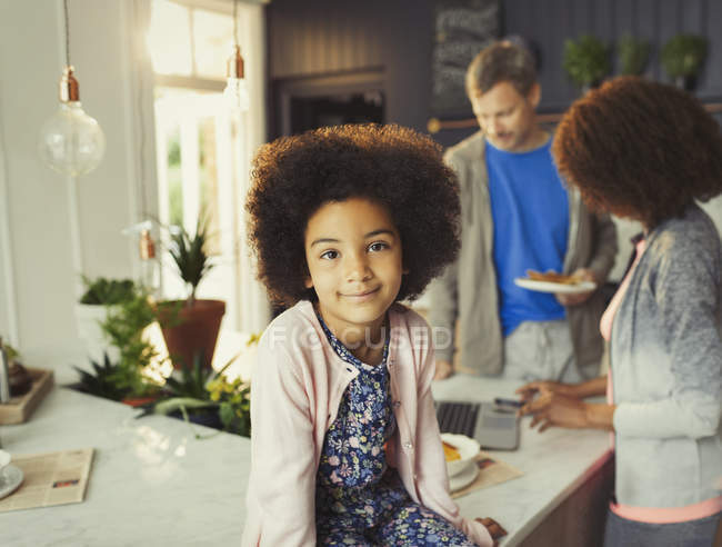 Portrait confident girl in kitchen with parents — Stock Photo