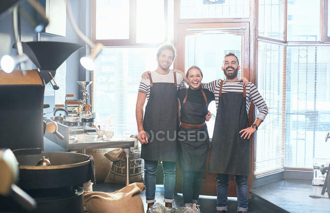 Portrait smiling coffee roasters in aprons — Stock Photo