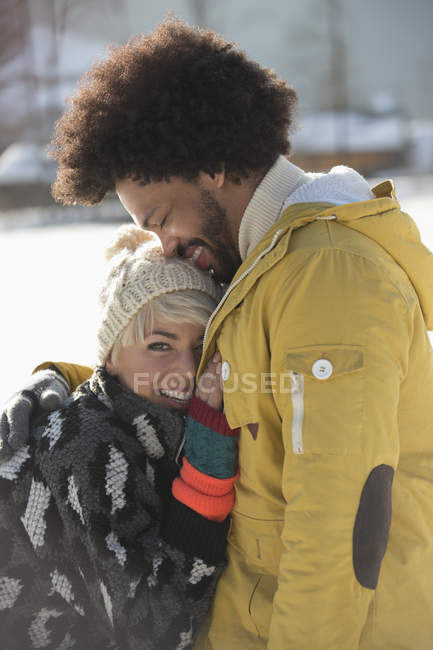 Couple hugging in snow — Stock Photo