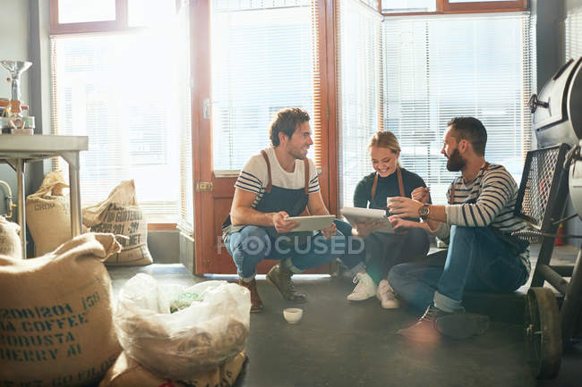 Coffee roasters with clipboard and digital tablet meeting — Stock Photo