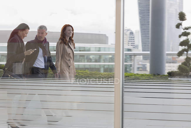 Business people walking on urban highrise balcony — Stock Photo