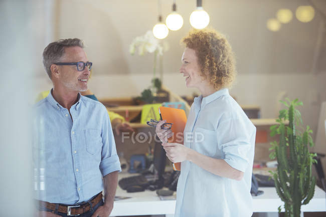 Three office workers talking at office — Stock Photo