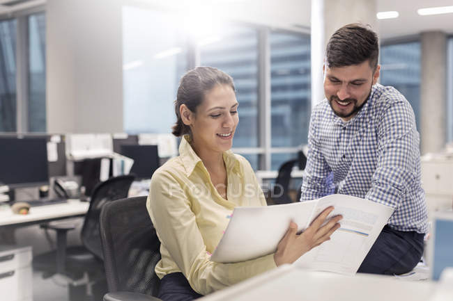 Business people reviewing paperwork in office — Stock Photo