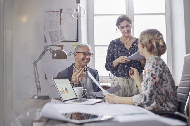 Business people planning, discussing paperwork in office meeting — Stock Photo