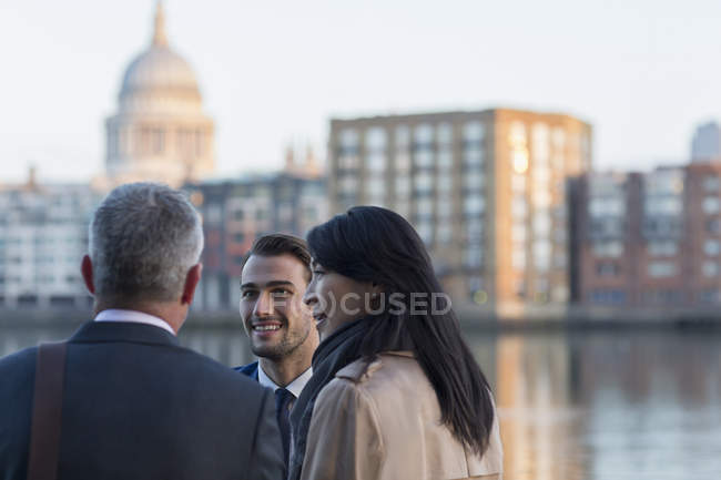 Business people talking at urban waterfront, London, UK — Stock Photo