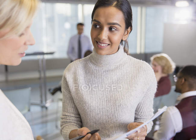 Businesswomen discussing paperwork in conference room meeting — Stock Photo