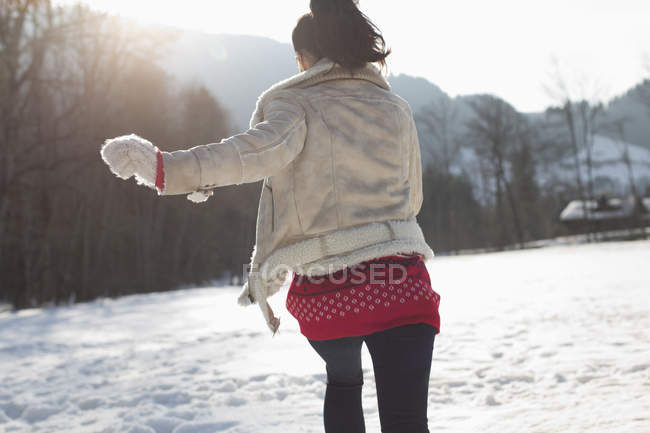 Woman running in snow — Stock Photo