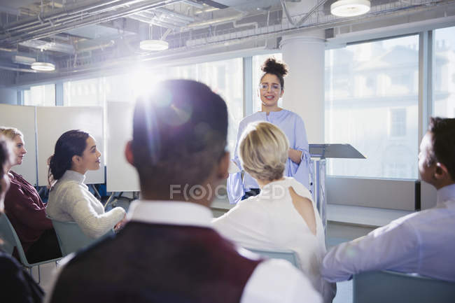 Businesswoman leading conference presentation, answering audience questions — Stock Photo