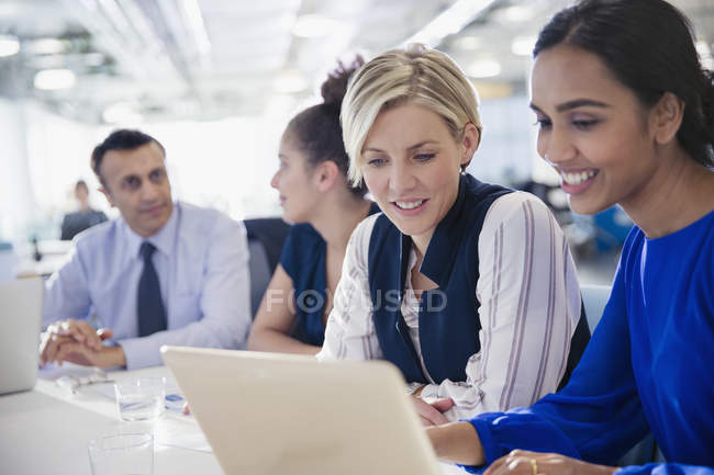 Businesswomen working at laptop in office meeting — Stock Photo