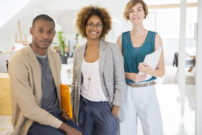Portrait of smiling office workers in modern office — Stock Photo