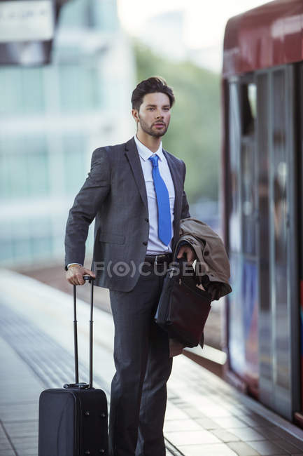 Businessman waiting at train station — Stock Photo