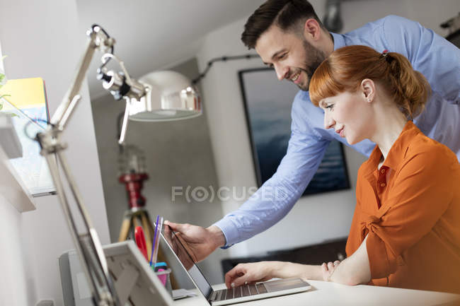 Business people using laptop in office — Stock Photo