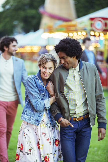 Young multiracial couple smiling in amusement park — Stock Photo