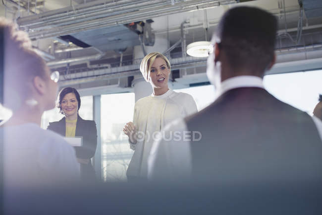 Business people talking in conference audience — Stock Photo