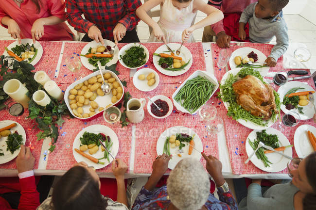 Overhead view family eating Christmas dinner — Stock Photo