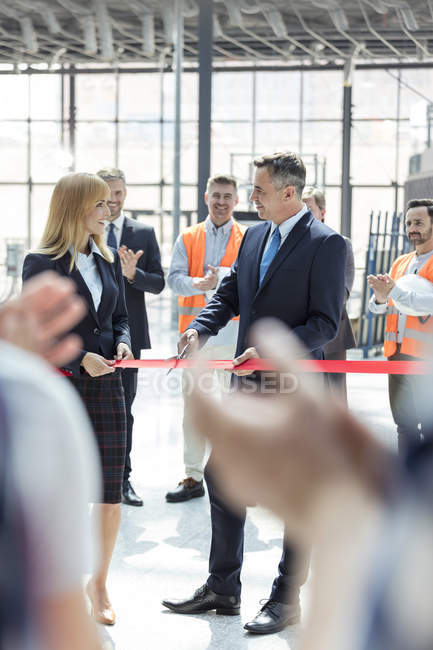 Business people cutting ribbon at new construction site ceremony — Stock Photo