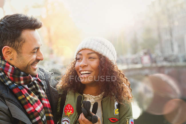 Laughing young couple along autumn canal — Stock Photo
