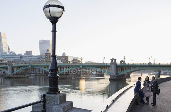 Des gens d'affaires parlent au bord de l'eau urbain, Londres, Royaume-Uni — Photo de stock