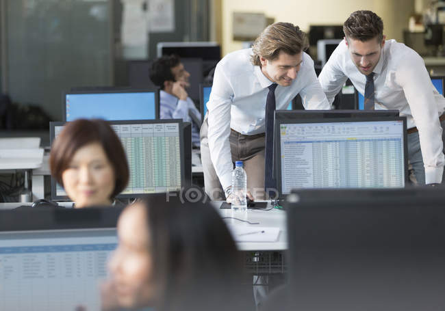 Бизнесмены, работающие за компьютером в современном офисе — стоковое фото
