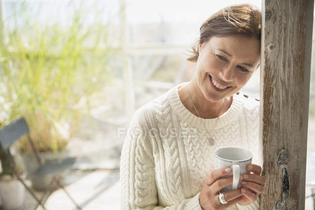 Portrait smiling mature woman drinking coffee — Stock Photo