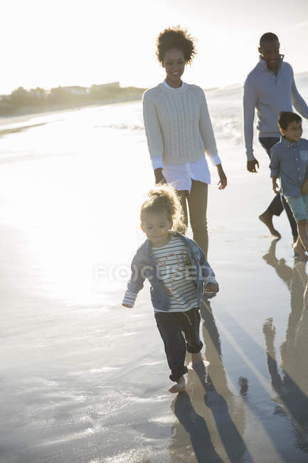 Happy walking on beach at sunset — Stock Photo