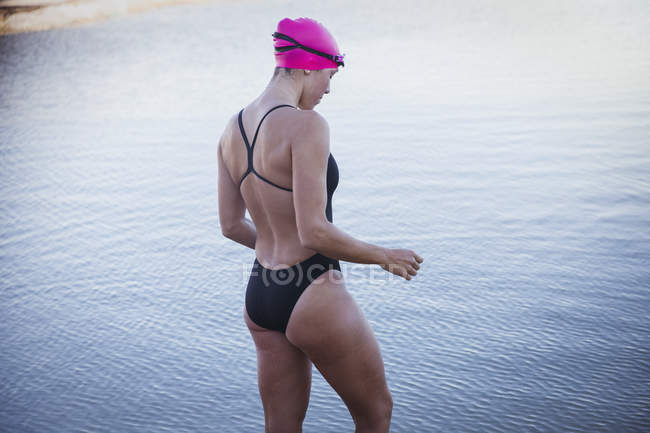 Female open water swimmer wading in ocean — Stock Photo