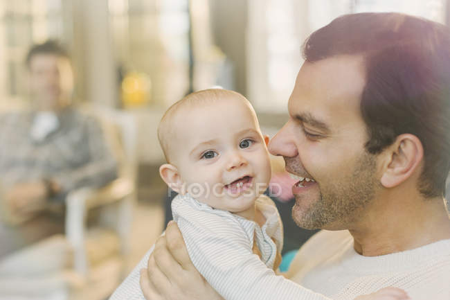Portrait happy father holding cute baby son — Stock Photo