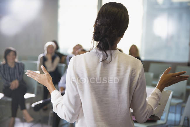 Businesswoman gesturing, leading conference room meeting — Stock Photo