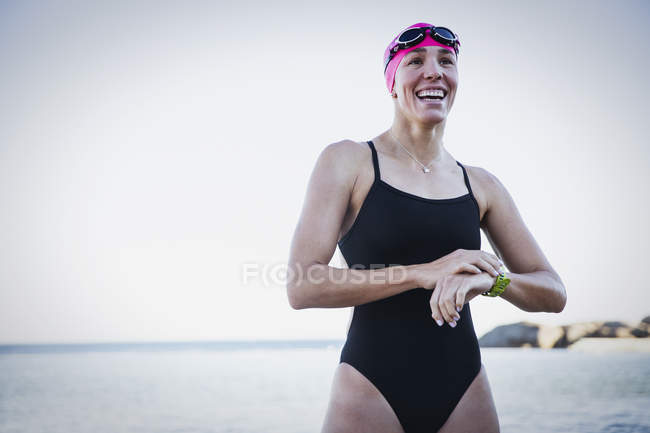Female smiling swimmer standing at ocean outdoors — Stock Photo