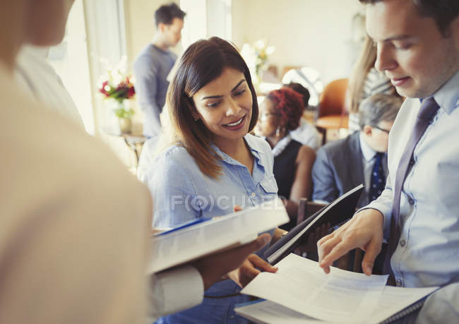Business people discussing paperwork at business conference — Stock Photo